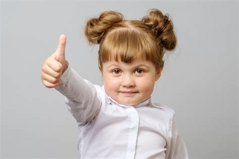 Portrait Of Cute Girl Showing Thumbs Up Sign Paid Paid Sponsored