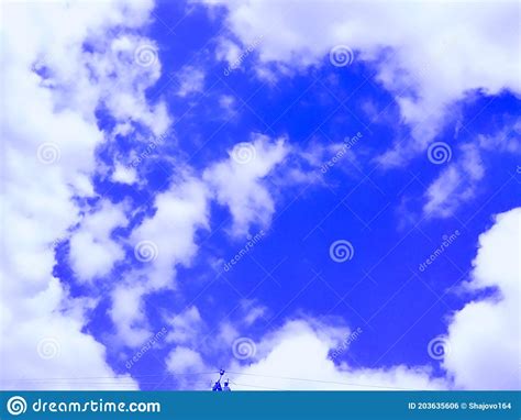 Bright Blue Sky In The Areola Of Fluffy White Clouds Stock Photo