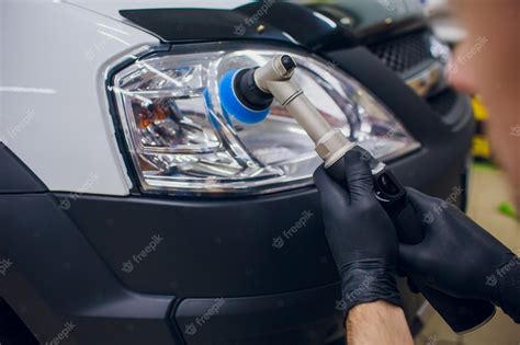 Premium Photo Auto Mechanic Buffing And Polishing Car Headlight