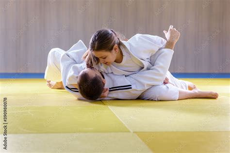 Young Female Judoka Holds Older Male Judoka With Kesa Gatame Technique Foto De Stock Adobe Stock