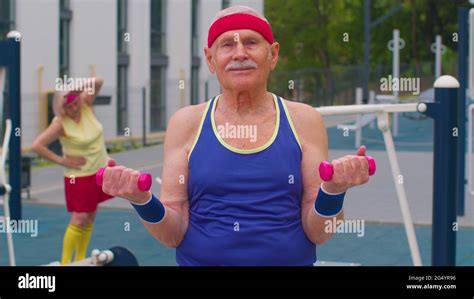 Senior Man Grandfather Doing Active Training Weightlifting Exercising With Dumbbell On