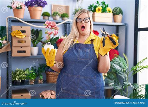 Caucasian Plus Size Woman Working At Florist Shop Afraid And Shocked