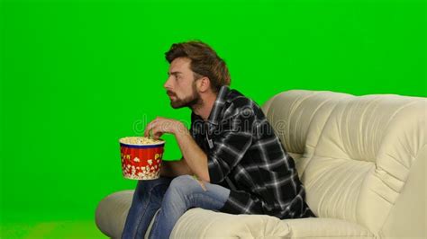 Guy Eating Popcorn Sitting On The Sofa Green Screen Stock Video Video Of American Attractive