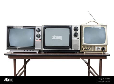 Three Vintage Televisions On Wood Table Isolated On White With Clipping