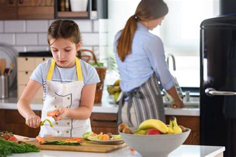 Mother Teaching Child To Cook And Help In The Kitchen Stock Image