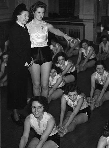 An Old Black And White Photo Of Women In Cheerleader Outfits Posing For The Camera