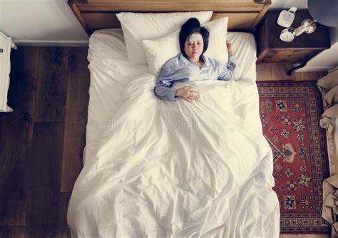 sick asian woman with fever sleeping on the bed stock image image of condo illness 116460831