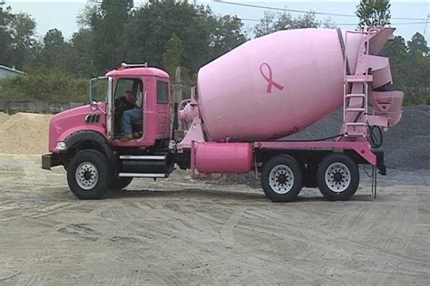 A Pink Cement Truck Parked In A Parking Lot