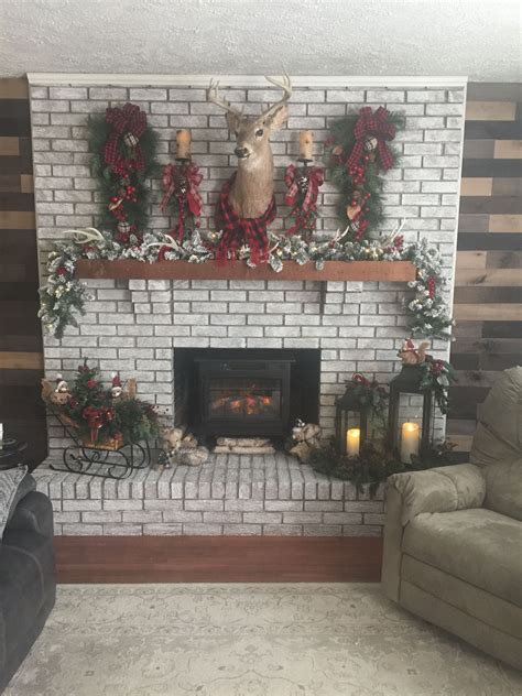 A figurine of white winged deer decorating with light ornament on body. Christmas 2018 with the addition of the wood accent walls on either side of the fireplace. We ...