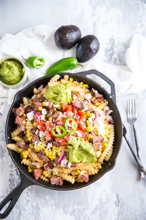 Top cooked fries with chopped carne asada and cheese. Carne Asada Fries | LemonsforLulu.com