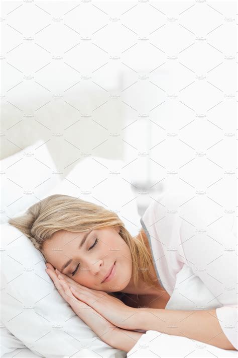 Woman Sleeping In Bed With Hands And Head Resting On The Pillow Stock