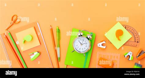 Back To School Styled Scene With Orange And Green School Supplies On