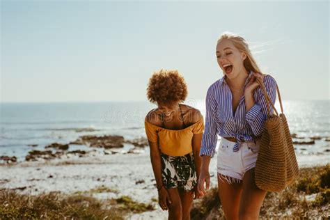 Two Happy Women Walking Along The Beach Stock Photo Image Of Multi Weekend