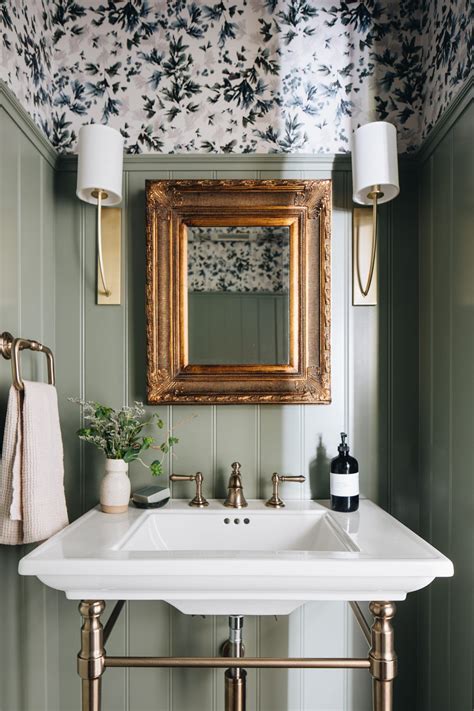 A Bathroom Sink Sitting Under A Mirror Next To A Wall Mounted Faucet In