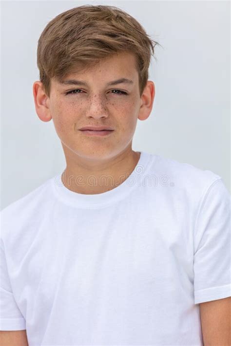 Boy Teenager Teen Male Child Smiling Happy And Wearing A White T Shirt