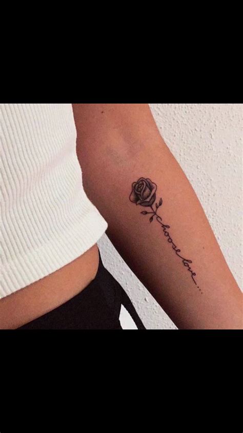 A Woman S Arm With A Rose On It And The Word Love Written In Cursive