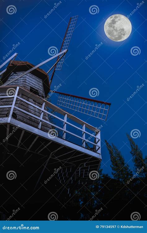 Beautiful Blue Sky And Bright Full Moon With Brown Windmill Out Stock