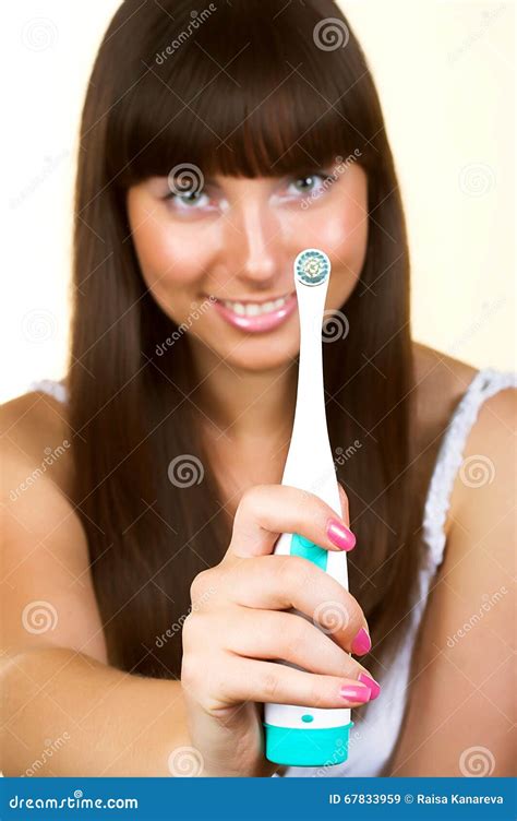 Smiling Woman With Great White Teeth Holding A Toothbrush Stock Image