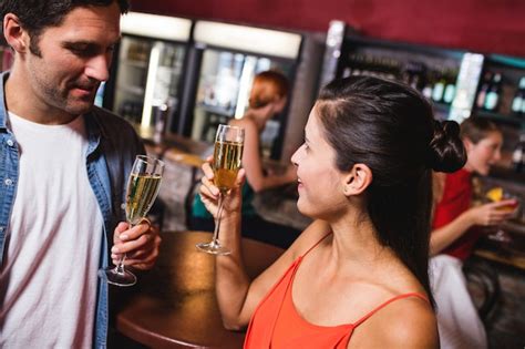 Premium Photo Couple Enjoying Champagne In Nightclub