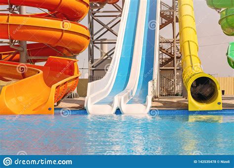 Multicoloured Big Water Slide In The Public Swimming Poolsun Light