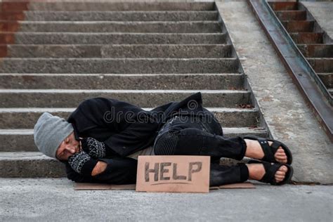 A Man Homeless A Man Sleeping On A Cold Floor In The Street With A