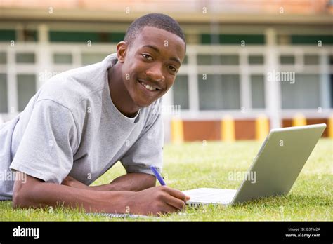 Student Lying Outdoors On Lawn With Laptop Stock Photo Alamy