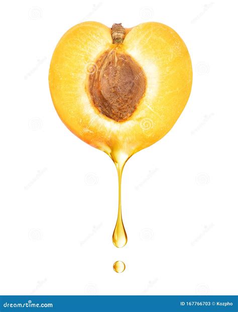 A Drop Dripping From A Half Of Apricot Close Up On A White Background