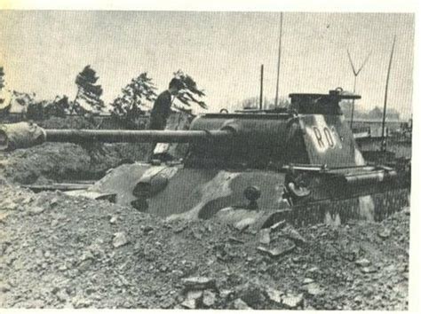An Old Tank Sitting On Top Of A Pile Of Dirt