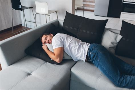 Premium Photo Tired Exhausted Guy Lying On Couch In Horizontal