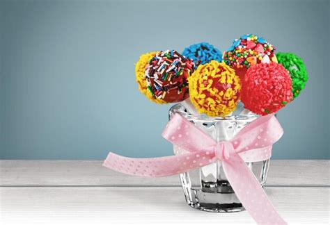 Premium Photo Sweet Lollipops On Sticks Bouquet In Vase With Bow