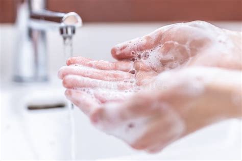 Washing Hands With Water And Liquid Soap In The Bathroom Stock Image