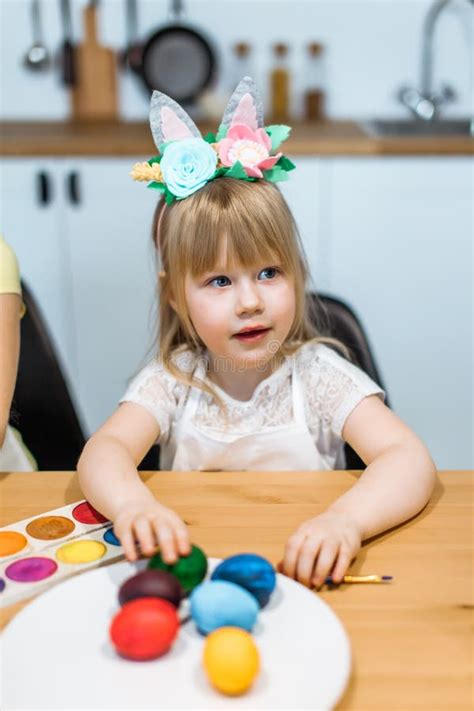 Cute Little Girl Show Painted Easter Eggs At Her Hands Stock Photo
