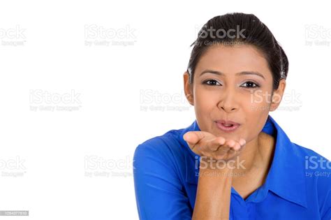 Portrait Of Pretty Young Woman Puckering Up Lips To Blow Kiss At Camera