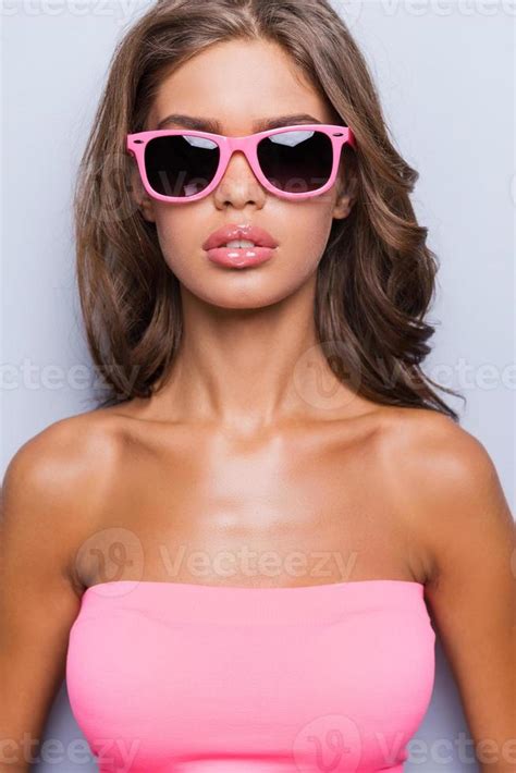 Lady In Pink Portrait Of Attractive Young Woman In Pink Tank Top And Sunglasses Looking At