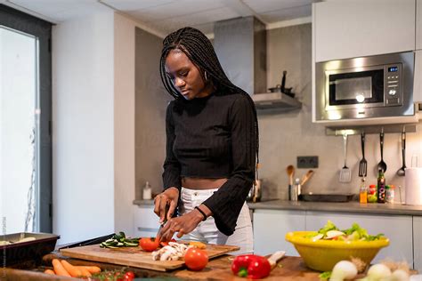 Black Woman Cooking At Home By Stocksy Contributor Luis Velasco Stocksy