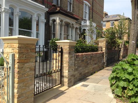 Front Garden Yellow Brick Wall With Buff Coping And Metal Rail And Gate