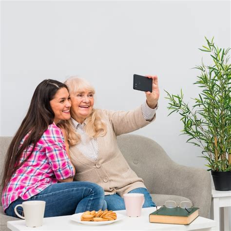Madre Sonriente Y Su Hija Joven Que Toman El Selfie En El Teléfono
