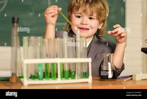 Little Boy At Elementary School Biology School Laboratory Equipment