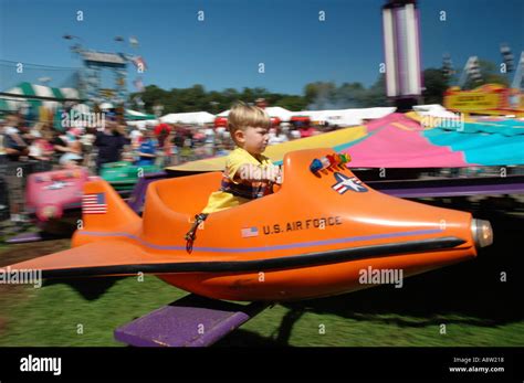 Small Boy Riding A Rocket Ride At A Carnival Stock Photo Alamy
