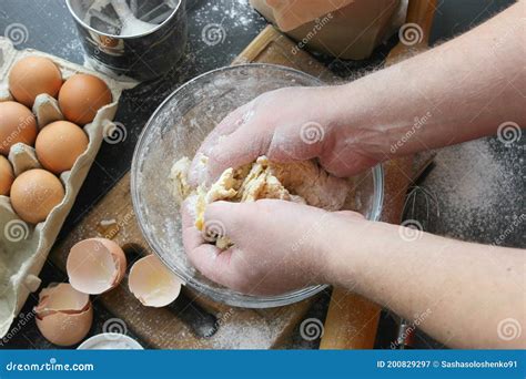 Hands Kneading Dough Ball Of Dough On A Rustic Wooden Background With