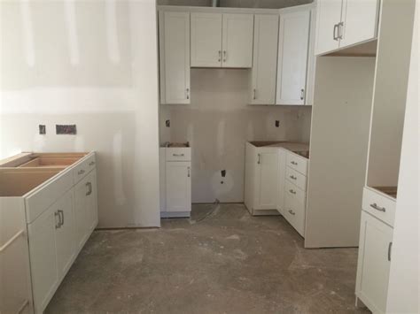 Providing a full scope of residential and commercial painting services. White kitchen. Shaker style cabinets (Timberlake Sonoma ...