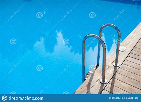 The Stainless Steel Railing Of The Stairs By The Pool With Water Stock