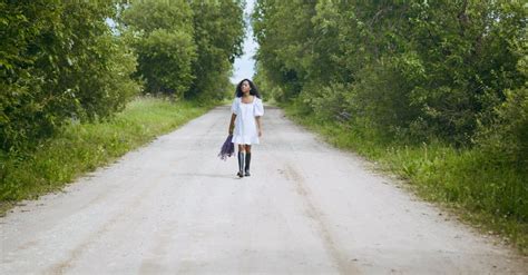 Woman In White Dress Walking Outdoors · Free Stock Video
