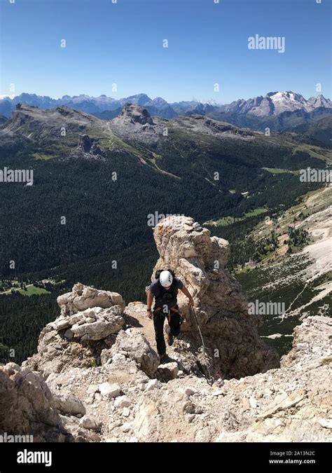 Mountain Guide On A Steep And Exposed Via Ferrata In Alta Badia In The