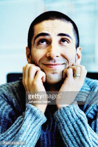Man Resting Chin In Hands Looking Upwards Closeup High Res Stock Photo