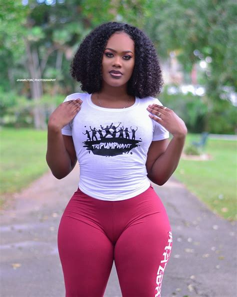 A Woman In Red Leggings And A White T Shirt Is Posing For The Camera