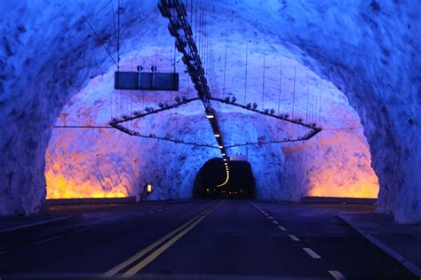 An Underground Tunnel With Lights And Snow On The Walls Is Lit Up By
