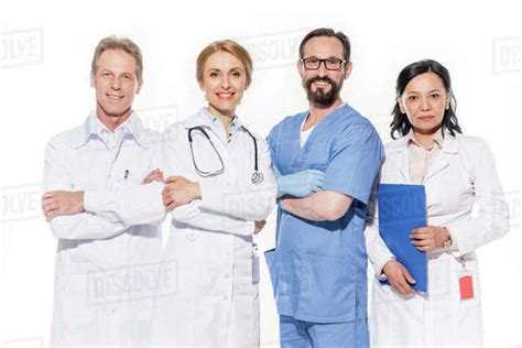 Professional Team Of Doctors Smiling At Camera Isolated On White