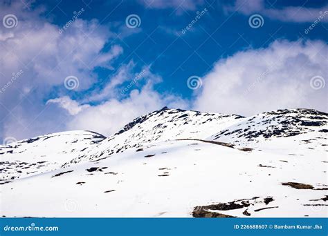 Snow Cap Mountains With Bright Blue Sky At Day From Flat Angle Stock