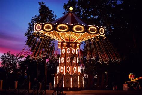 Premium Photo Carousel Merry Go Round In Amusement Park At Night City
